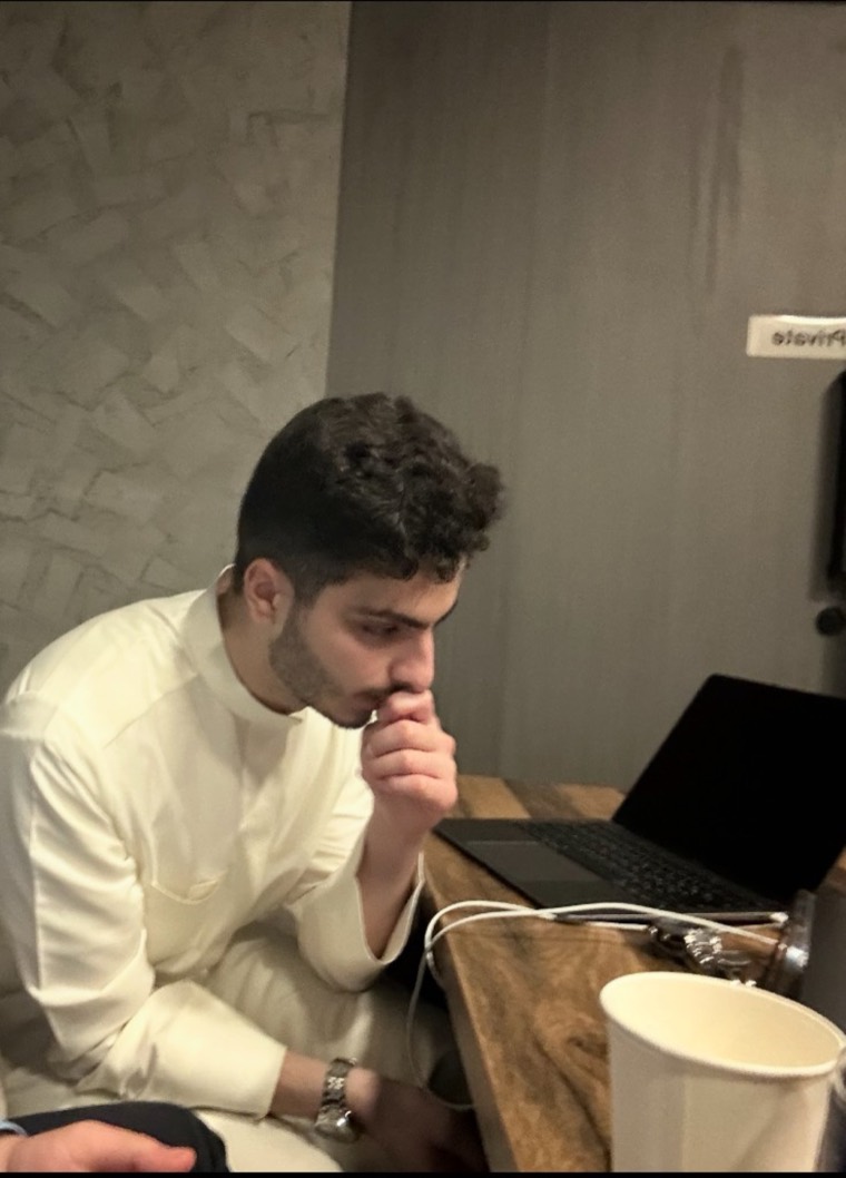 Zaid thinking at a laptop